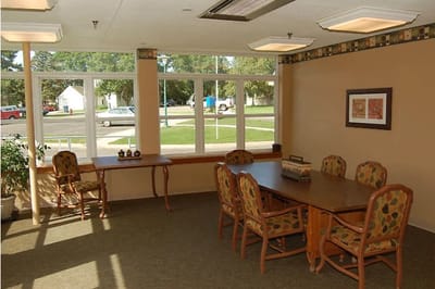 Common area with tables and chairs in a well-lit room