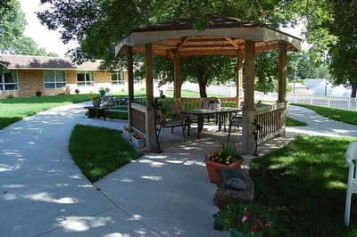 Outdoor gazebo area with seating and pathways