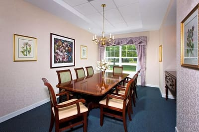 Dining area with a long wooden table and chairs