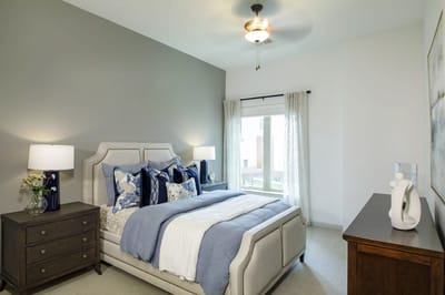 A well-decorated private resident room with a bed and window