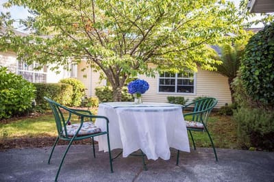 Outdoor table set in a landscaped garden