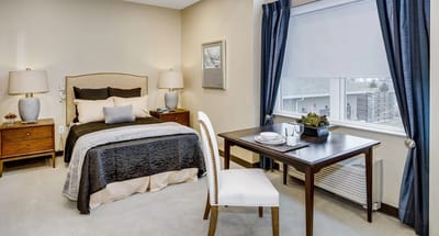 Cozy resident room with a bed and a dining table