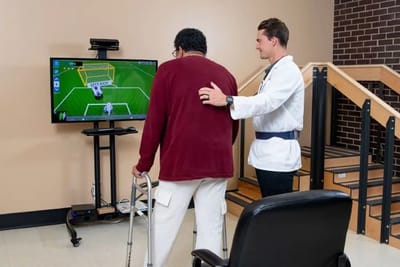 Therapist assisting a resident with rehabilitation activity