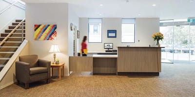 Bright reception area with seating and stairs