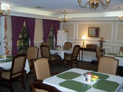 Dining area with tables and chairs set for meals
