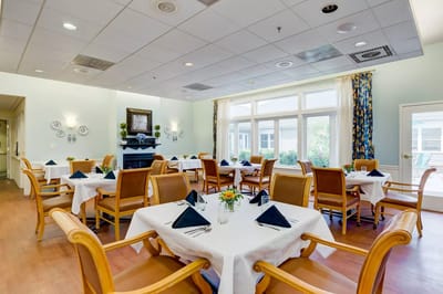 Cozy dining room with neatly set tables and chairs