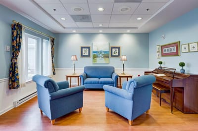 Bright common area with seating and piano