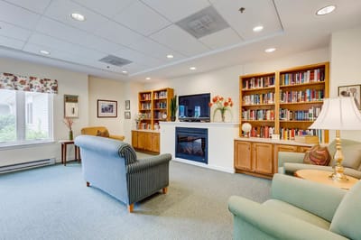 Interior lounge area with bookshelves and comfortable seating
