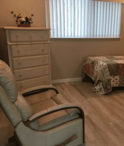 Cozy resident room with a dresser and chair