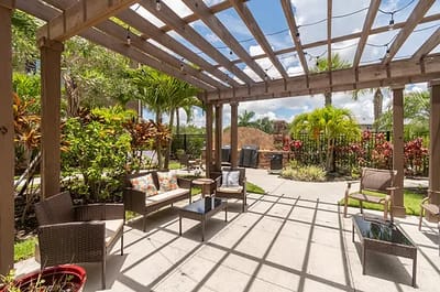 Outdoor seating area with plants and pergola