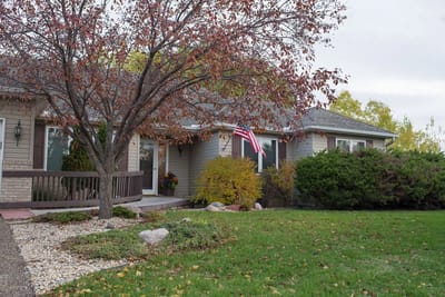 Exterior view of a senior living facility with an American flag