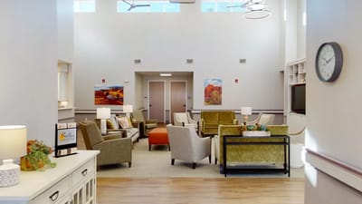 Bright common area with seating and paintings