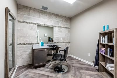 A bright, modern salon area with styling chair