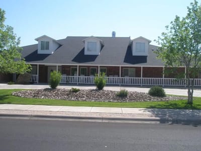 Exterior view of a senior living facility with landscaped gardens