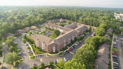 Aerial view of a senior living community with green spaces