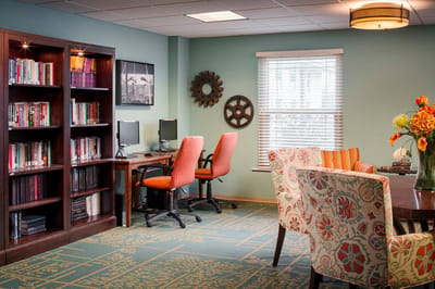 Interior common area with bookshelves and dining table