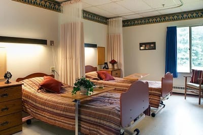 Neatly arranged shared resident room with twin beds