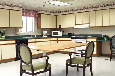Brightly lit kitchen with a table and chairs