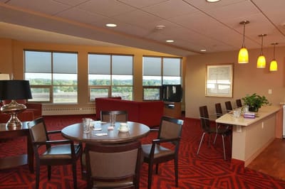Bright common area with seating and large windows