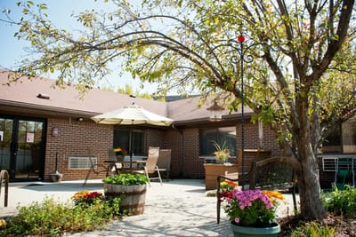 Outdoor seating area with flowers and greenery