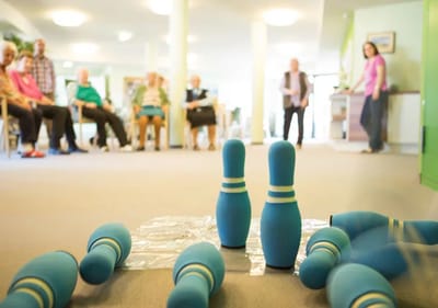 Residents participating in a fun indoor bowling activity