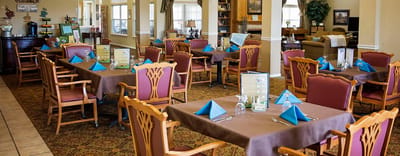 Dining area set up for a meal with blue napkins