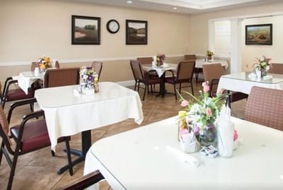 Dining area with tables and floral arrangements