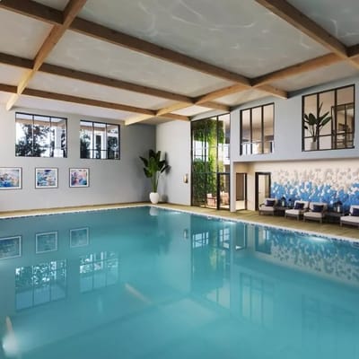 Indoor swimming pool area with seating