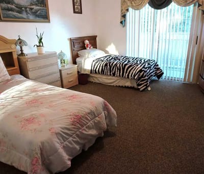 A cozy interior view of a resident's room with two beds