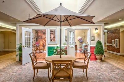 A cozy indoor seating area with a table and umbrellas