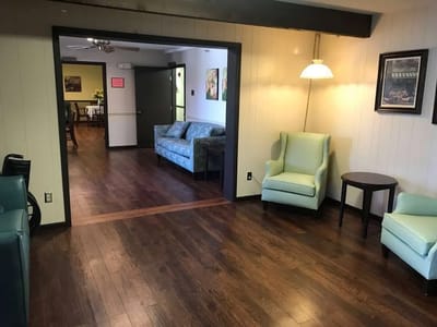Common lounge area with seating and wooden floors