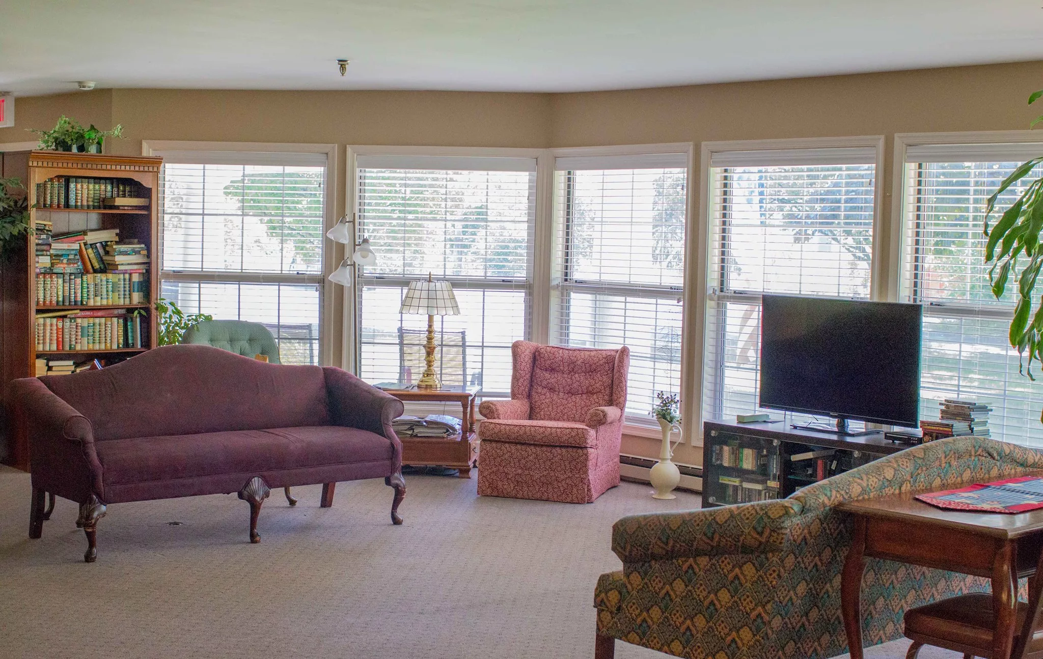 Comfortable common area with seating and bookshelves