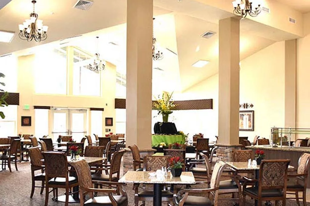Dining area with tables and chairs in a bright setting