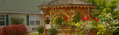 Outdoor gazebo surrounded by flowers in a garden