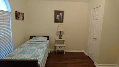 Cozy resident room with a bed and lamp
