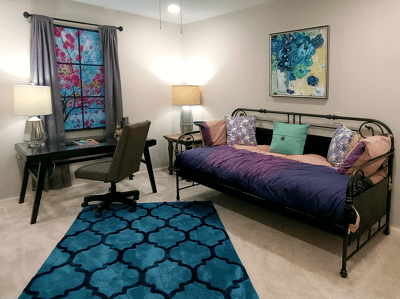 Cozy resident room with a daybed and desk