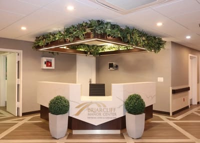 Reception area of Briarcliff Manor Center with greenery decorations