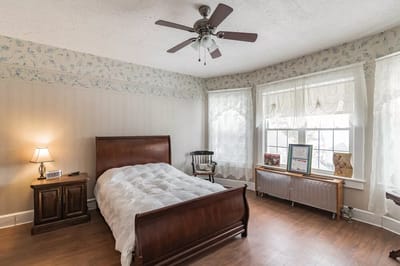 Cozy bedroom with a large window and wooden furniture