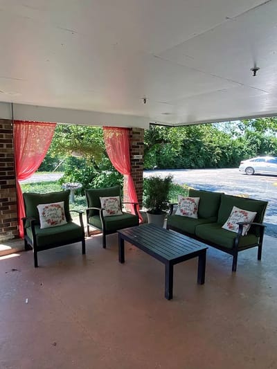 Outdoor seating area with cushions and curtains