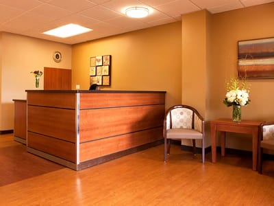 Modern reception area with wooden counter and seating