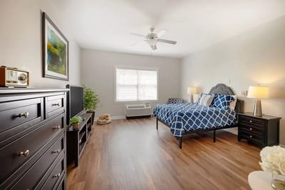 Well-lit resident room with furniture and decor
