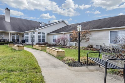 Pathway through landscaped garden area with seating
