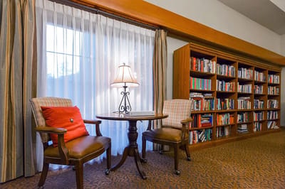 Cozy reading area with bookshelves and chairs