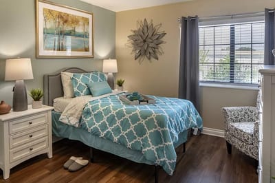 Cozy resident room with blue bedding and decorative art