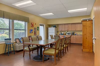 Bright common area with a large table and chairs