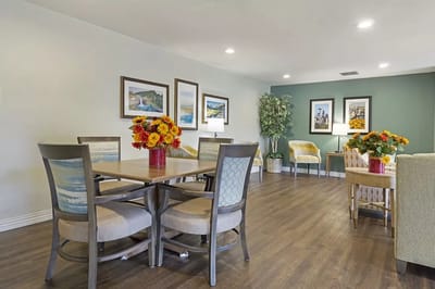 Bright common area with tables and flower decorations