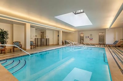 Indoor swimming pool area with lounge chairs