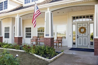 Front entrance of Brookdale Georgetown with seating and landscaping