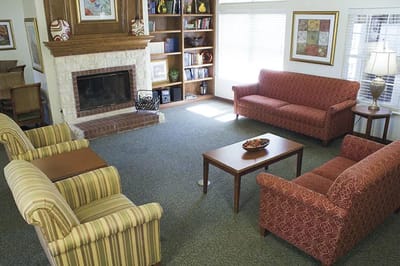 Cozy common area with seating and bookshelves