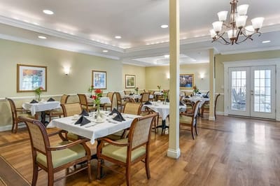 Bright dining room with tables set for meals